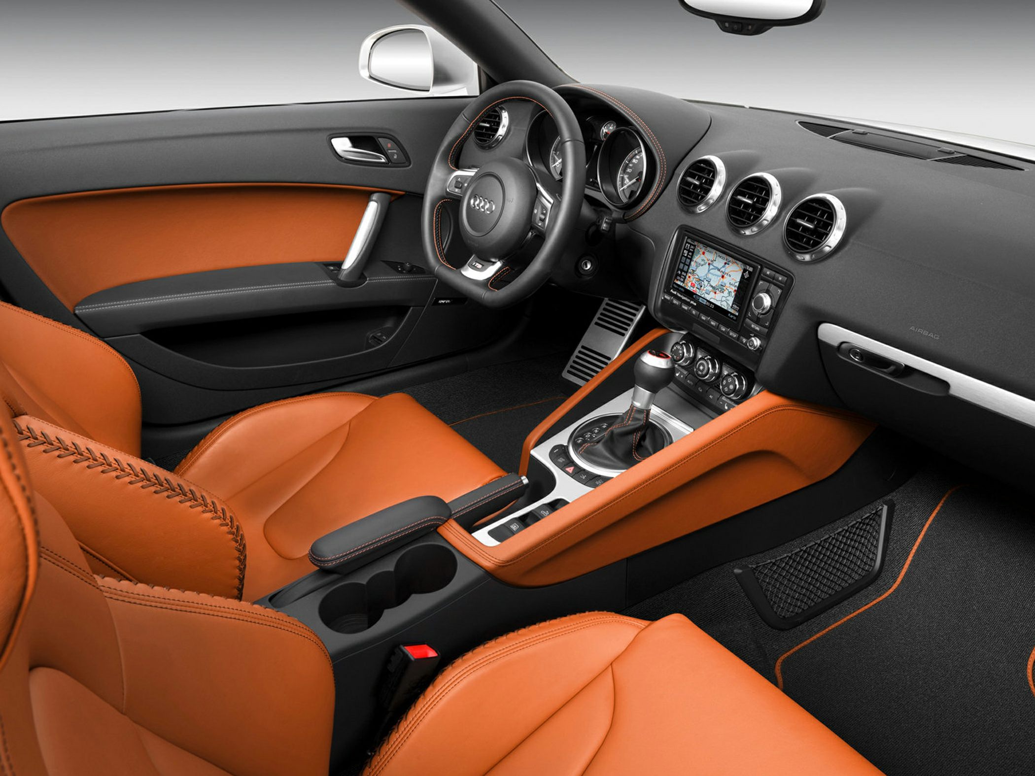 Premium orange leather seats and detailed stitching with advanced dashboard and controls