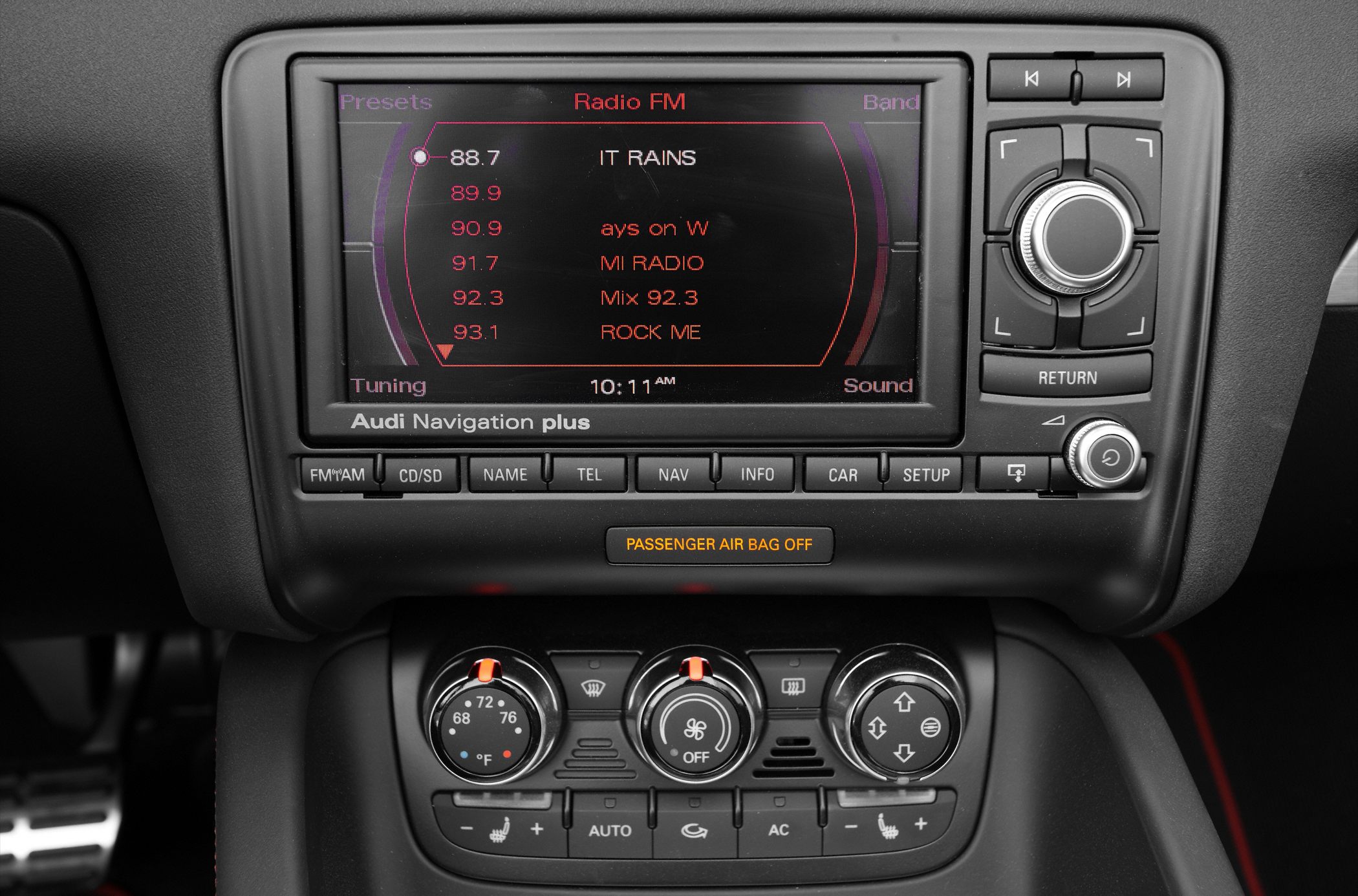 Car infotainment system with FM radio and manual climate control dials