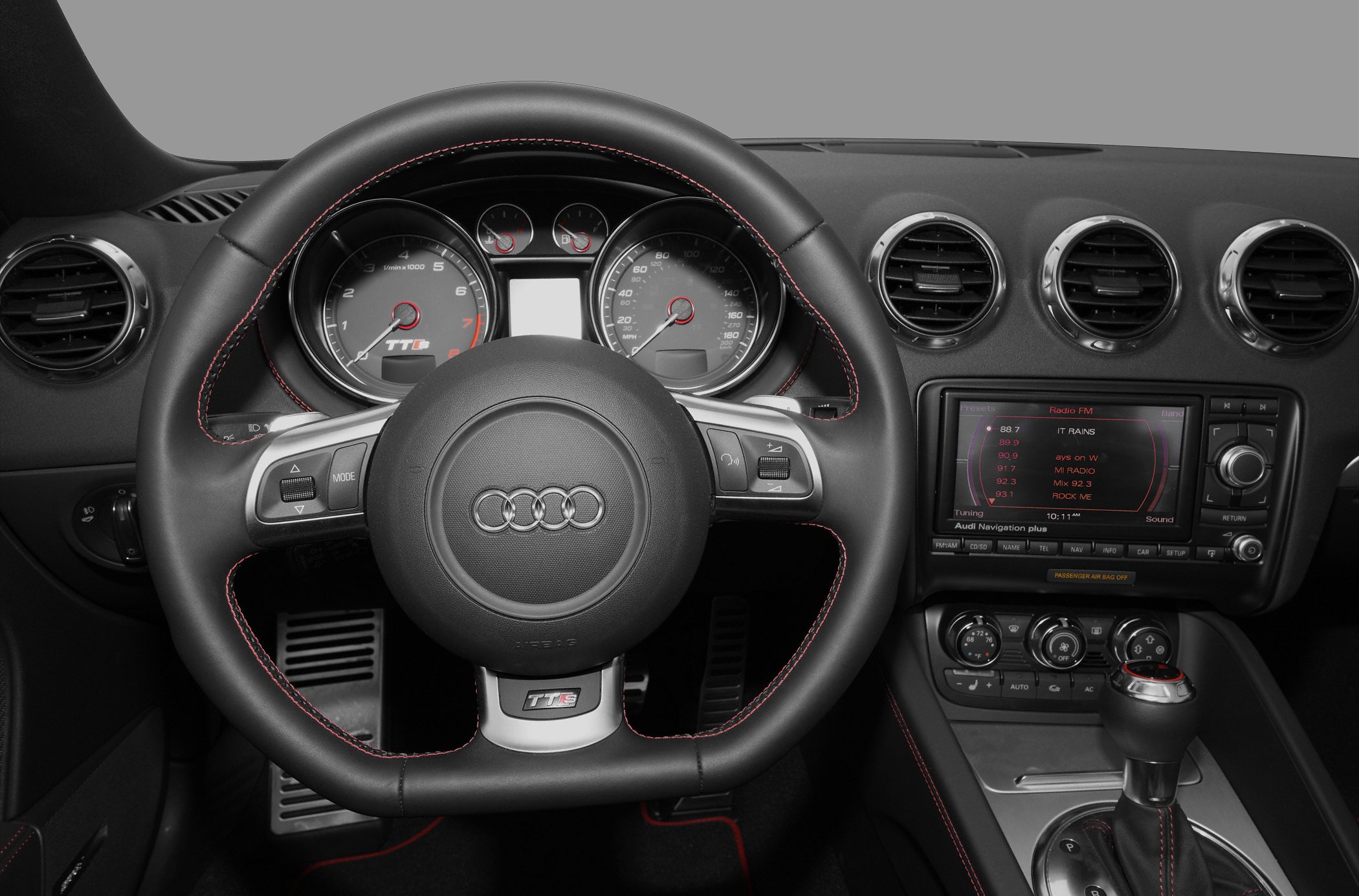 Audi TTS Roadster interior with sporty steering wheel and dashboard instruments