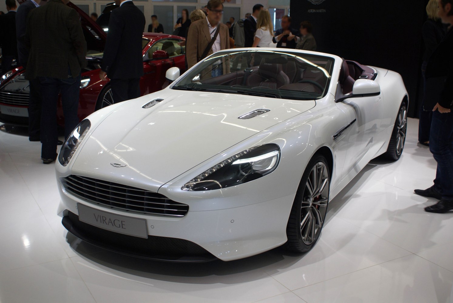 White convertible with hood vents, modern headlights, and stylish alloy wheels