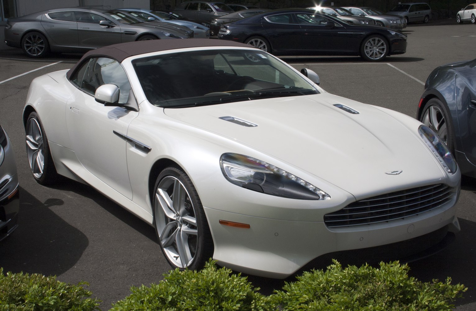 White convertible luxury sports car with sleek front and alloy wheels