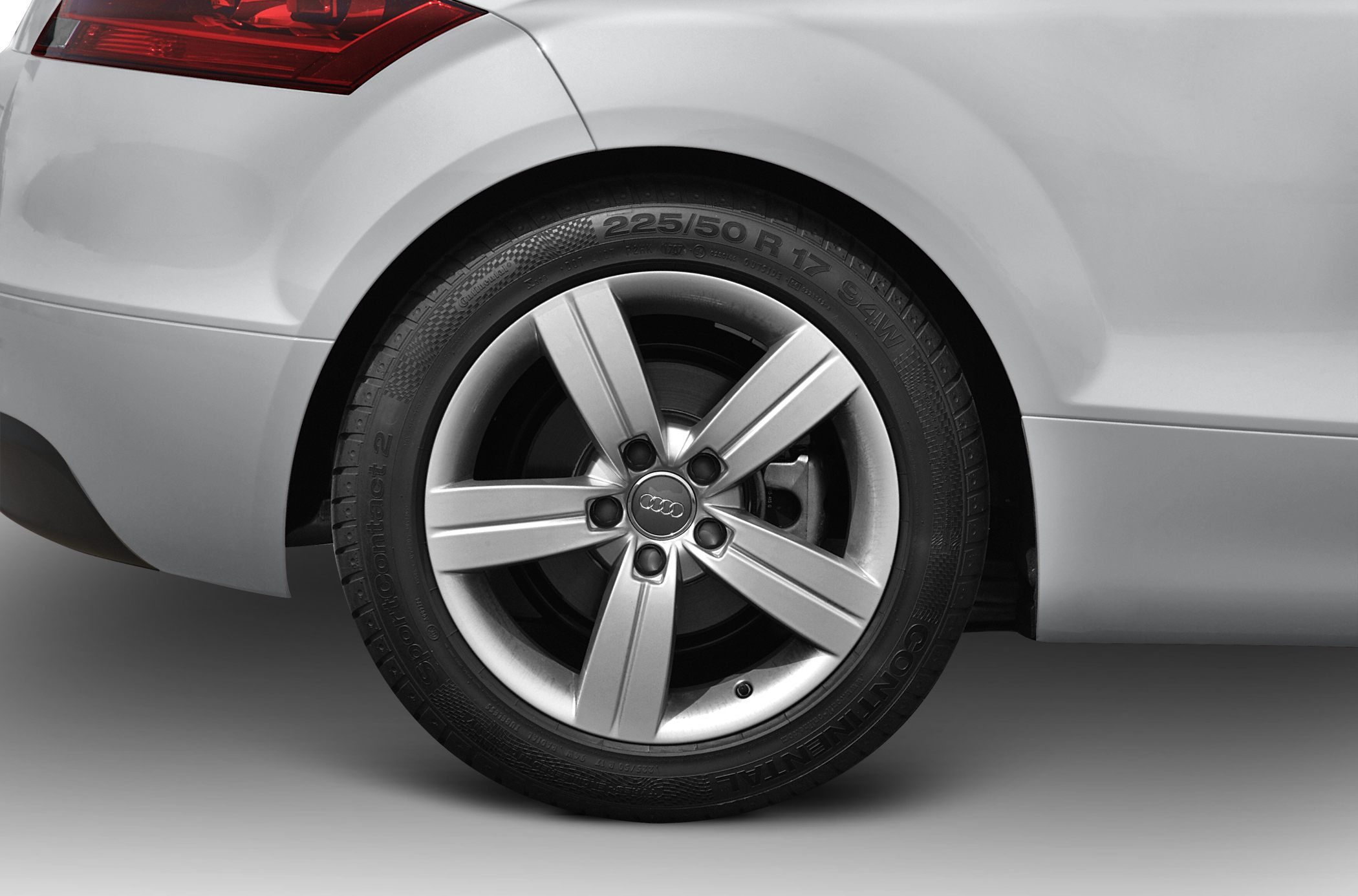 Close-up of alloy wheel and rear fender section with tire