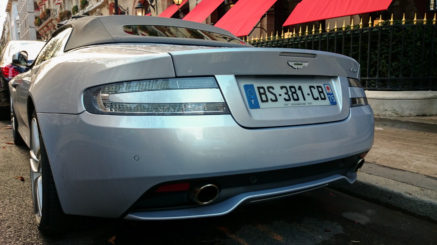 Rear view showing taillights, dual exhausts, and convertible roof