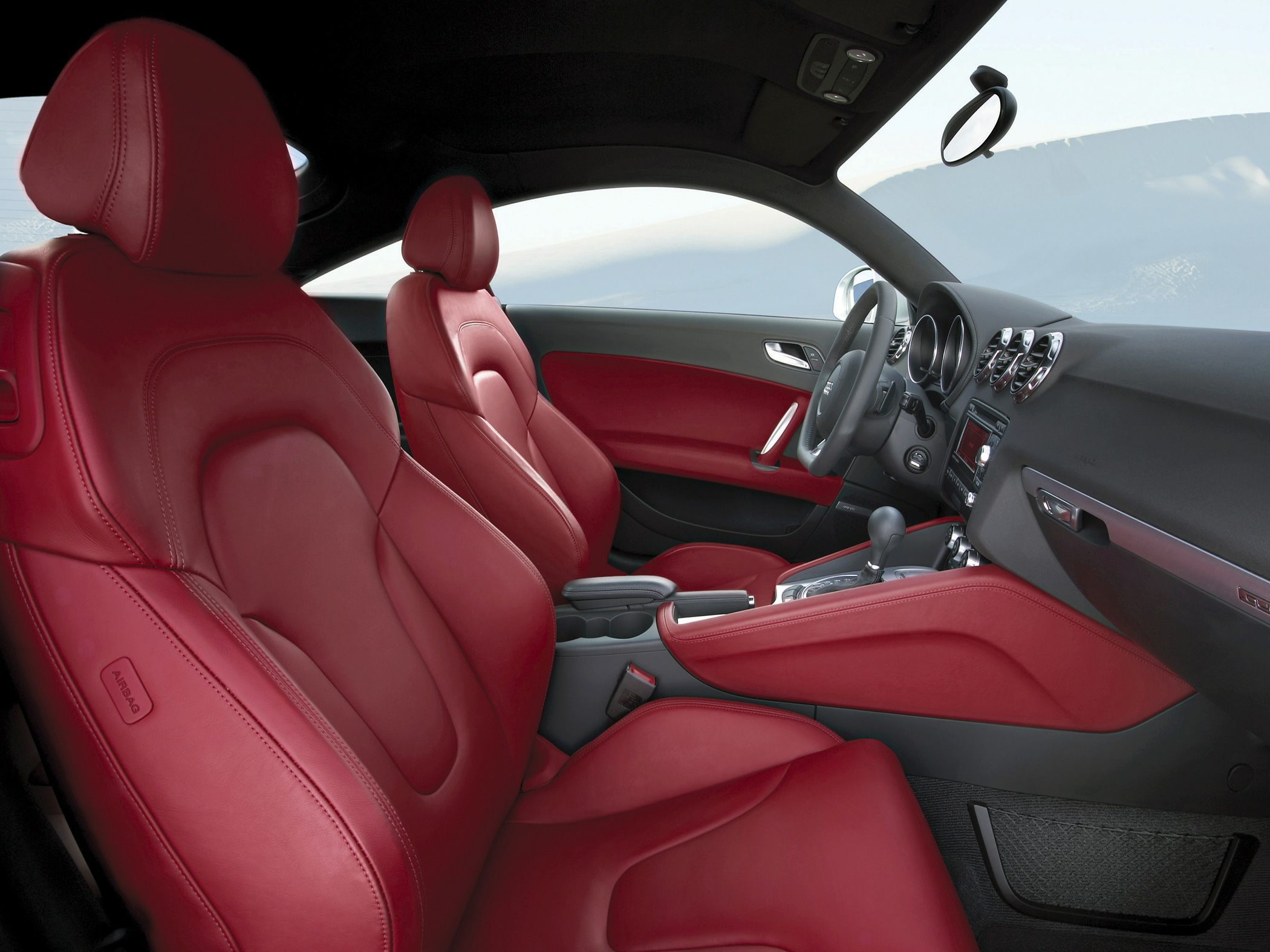 Red leather seats and dashboard in sporty coupe interior
