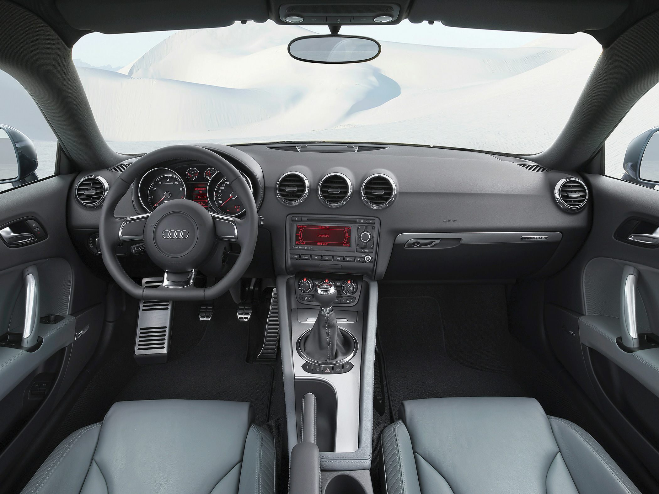 Dashboard, steering wheel, and manual gear shift in car interior