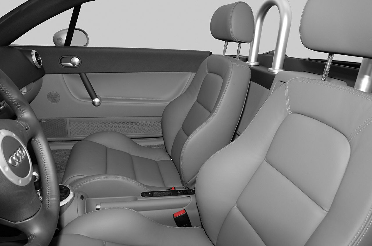 Luxurious front seats and polished roll bars inside a two-seater roadster