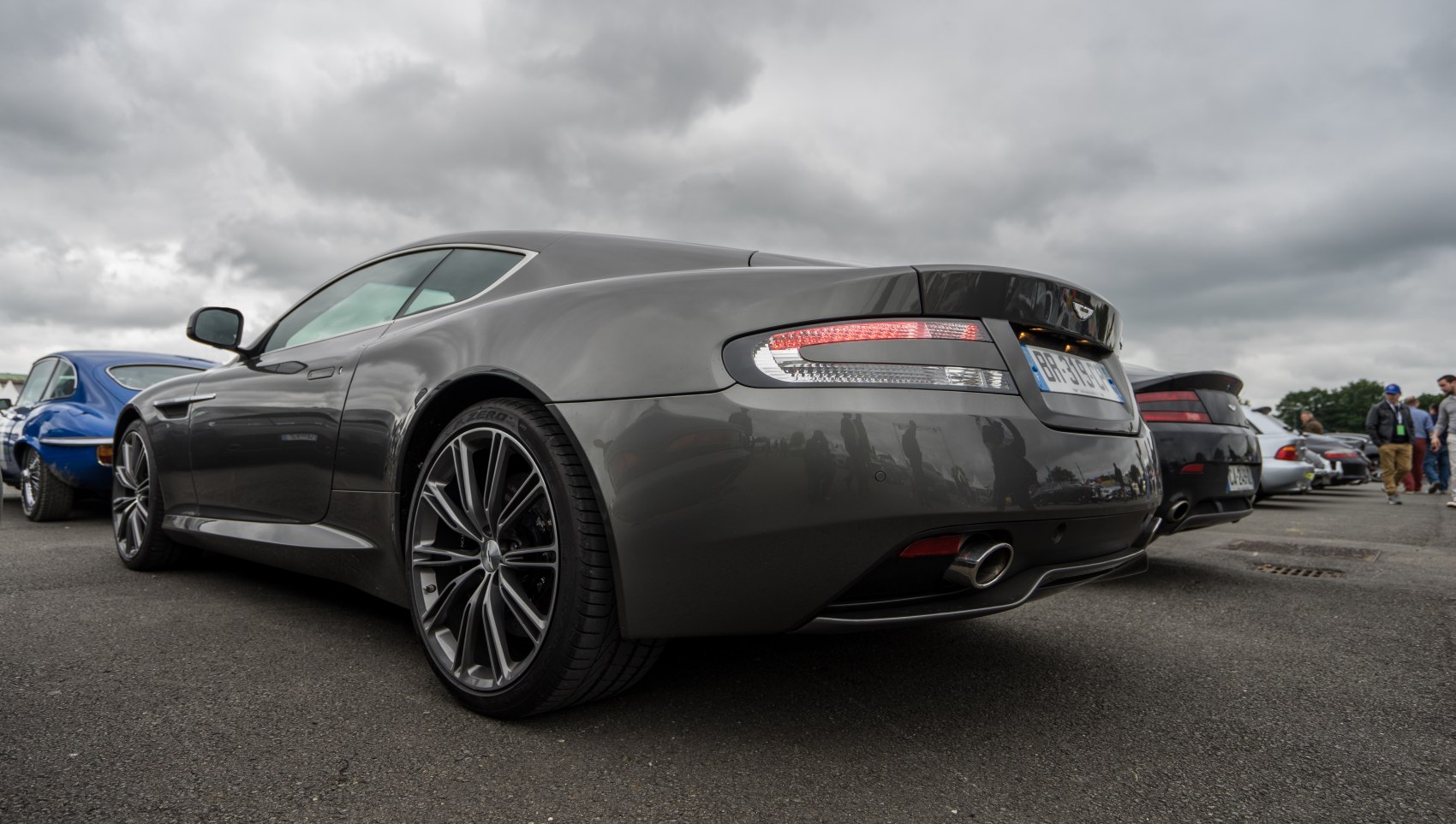 Rear view of luxury coupe with alloy wheels and dual exhaust pipes