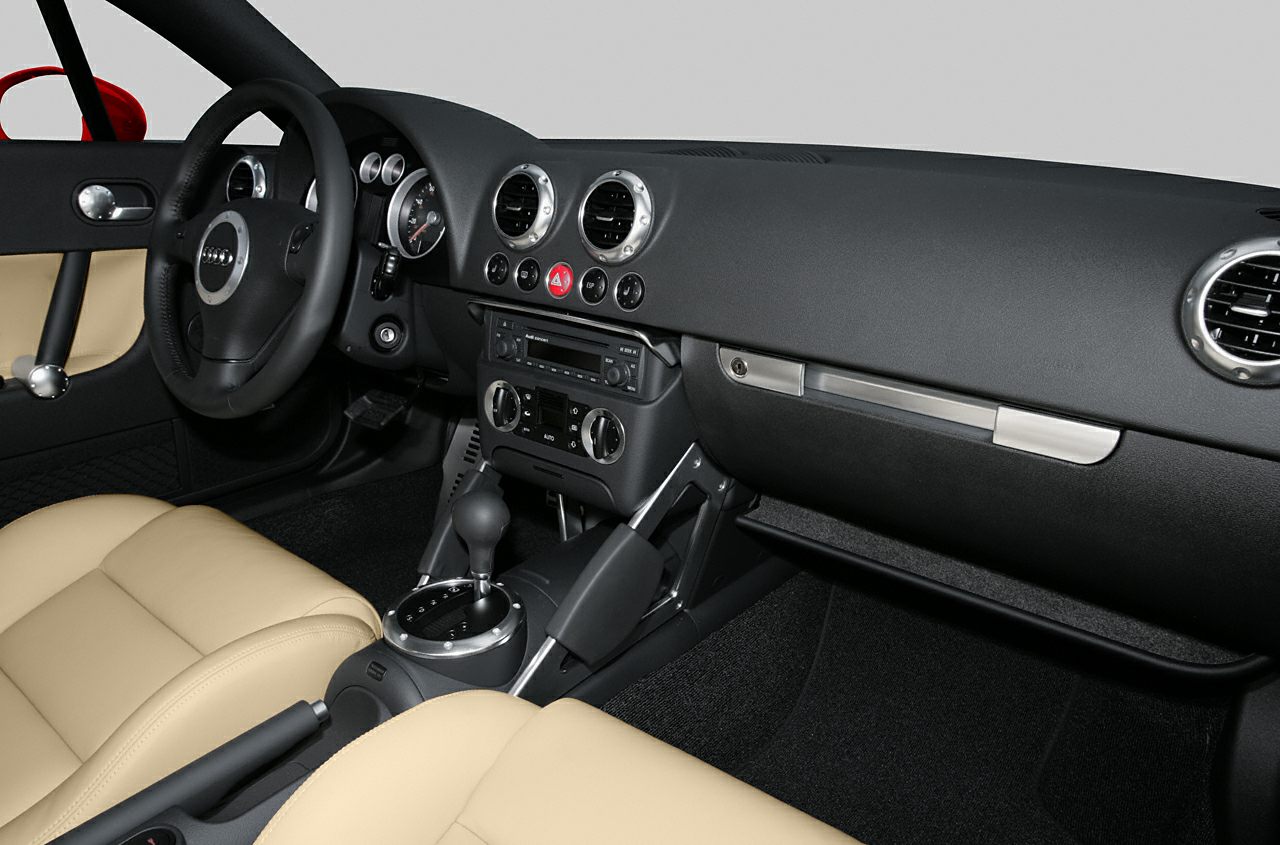 Dashboard with circular vents, gear shift, beige seats