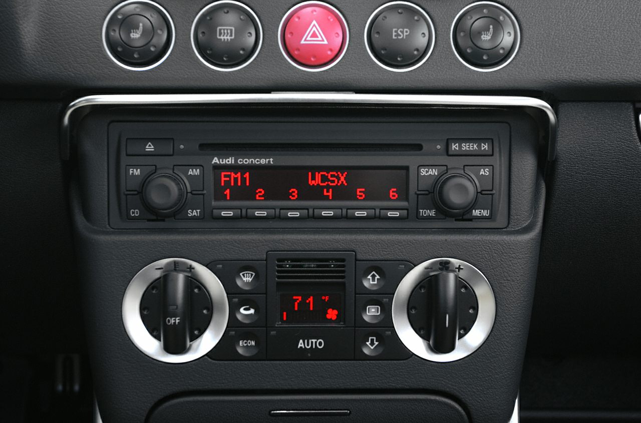 Classic car radio and climate control panel with distinctive buttons and dials