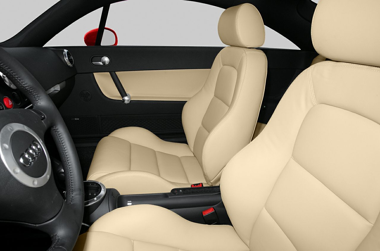 Beige leather seats and black dashboard of a sport coupe interior