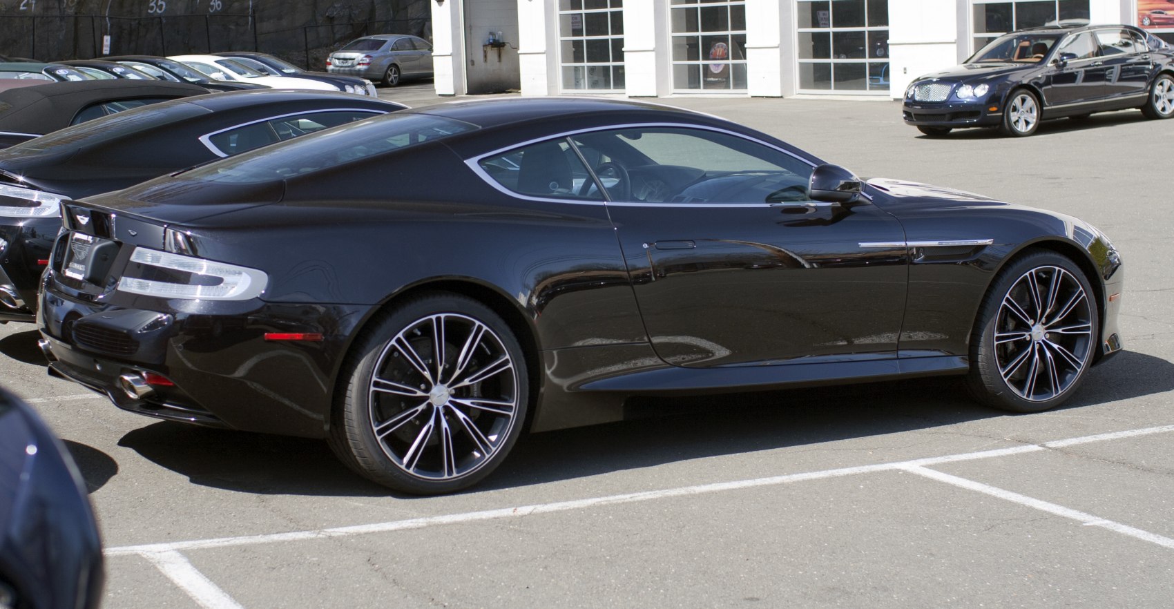 Black luxury coupe with sleek design and striking wheels
