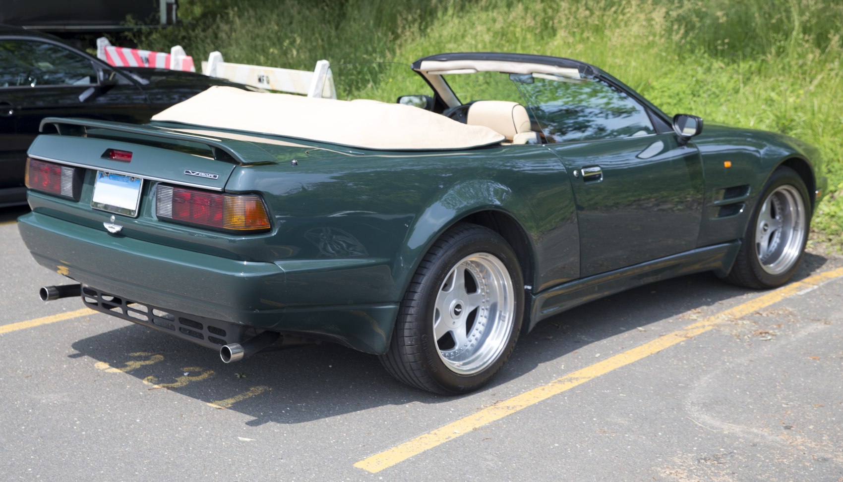 Convertible rear view with distinct tail lights and rear spoiler