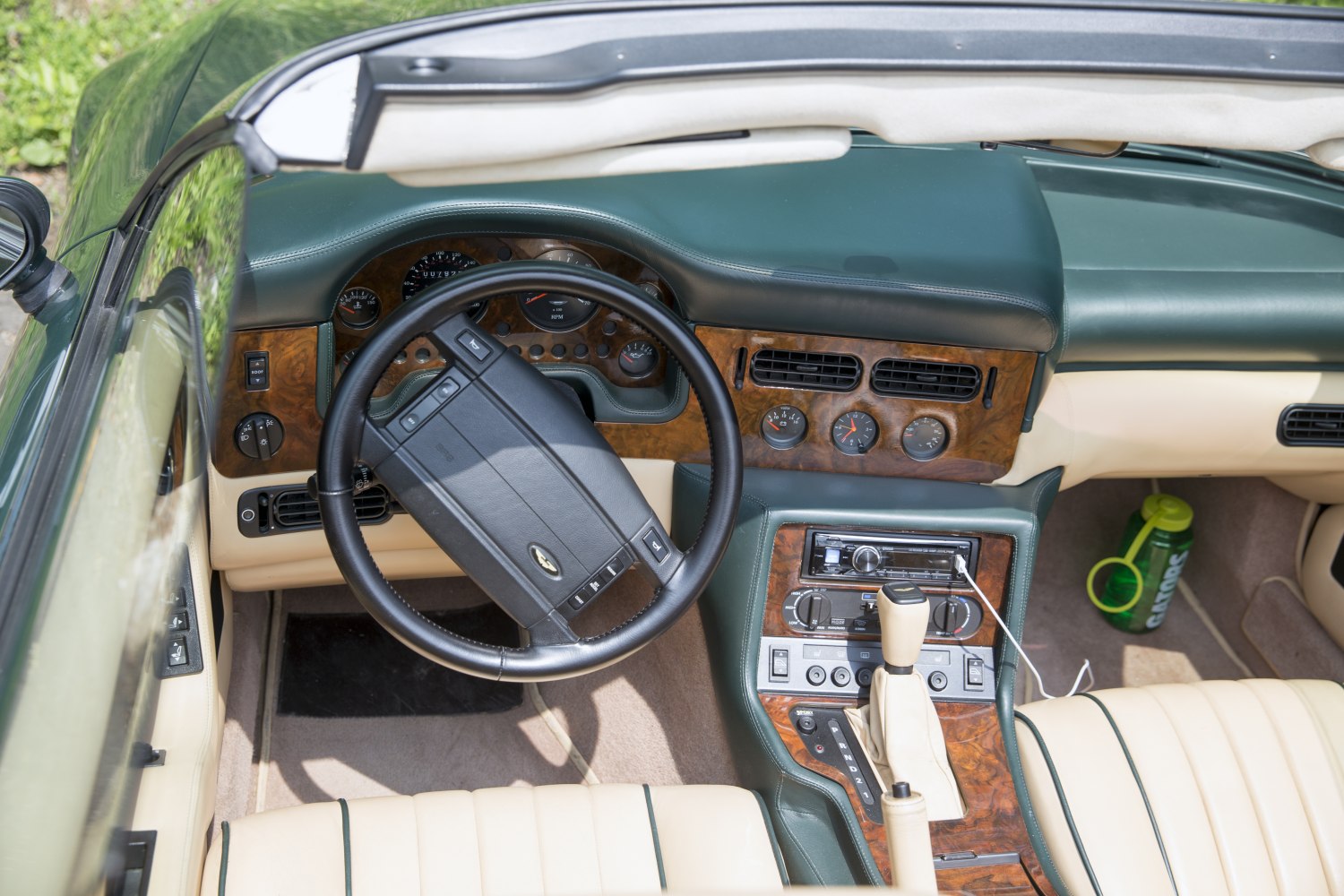 Wood trim dashboard and leather steering wheel in vintage luxury convertible interior