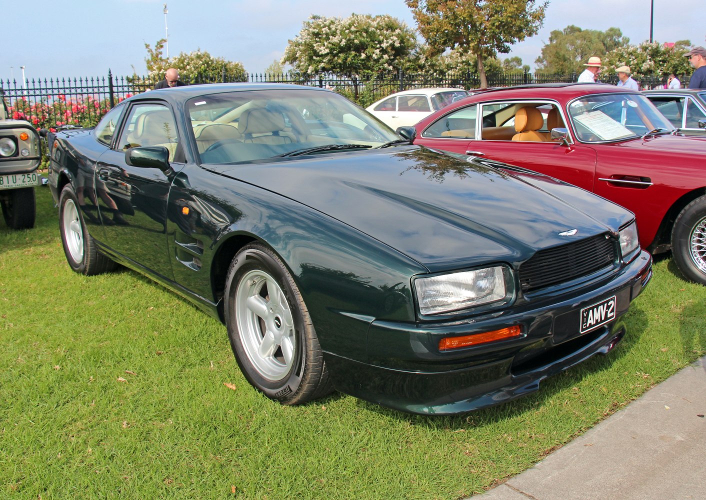 Front 3-4 view of a sleek vintage sports coupe with prominent headlights and distinct wheel design