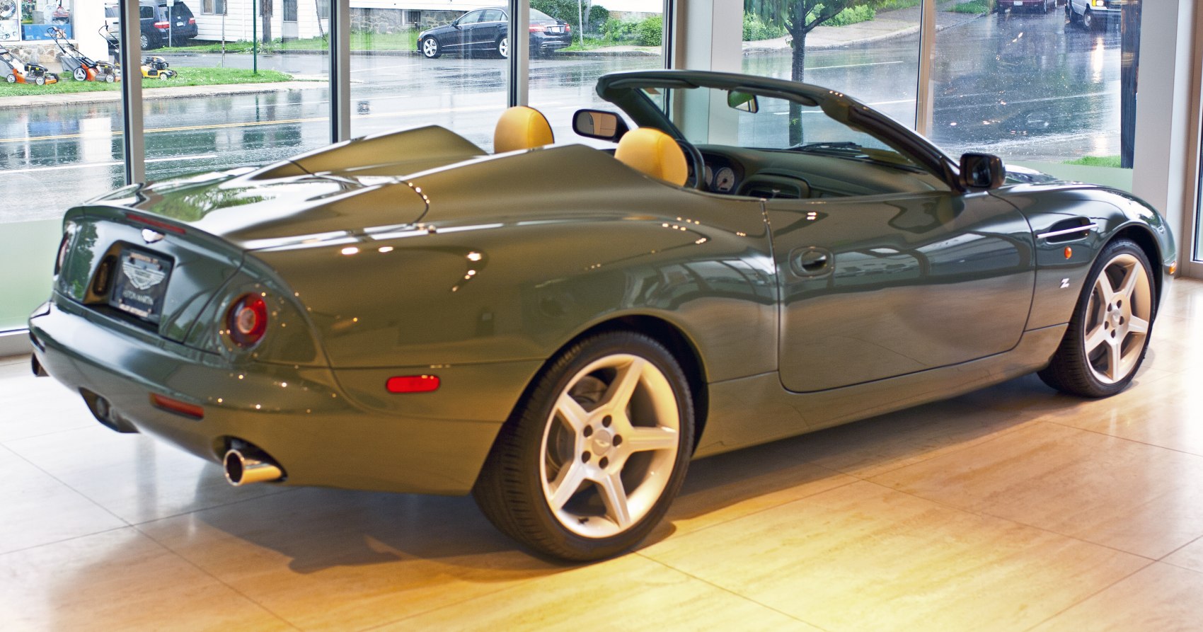 Rear and side view of convertible with beige seats and alloy wheels