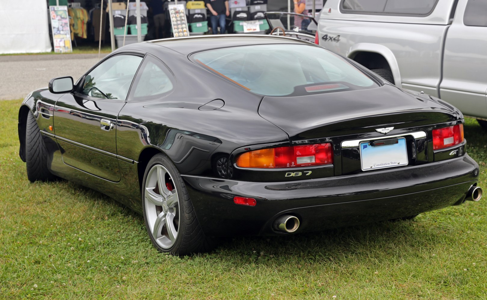 Black coupe rear side with dual exhaust and distinctive taillights