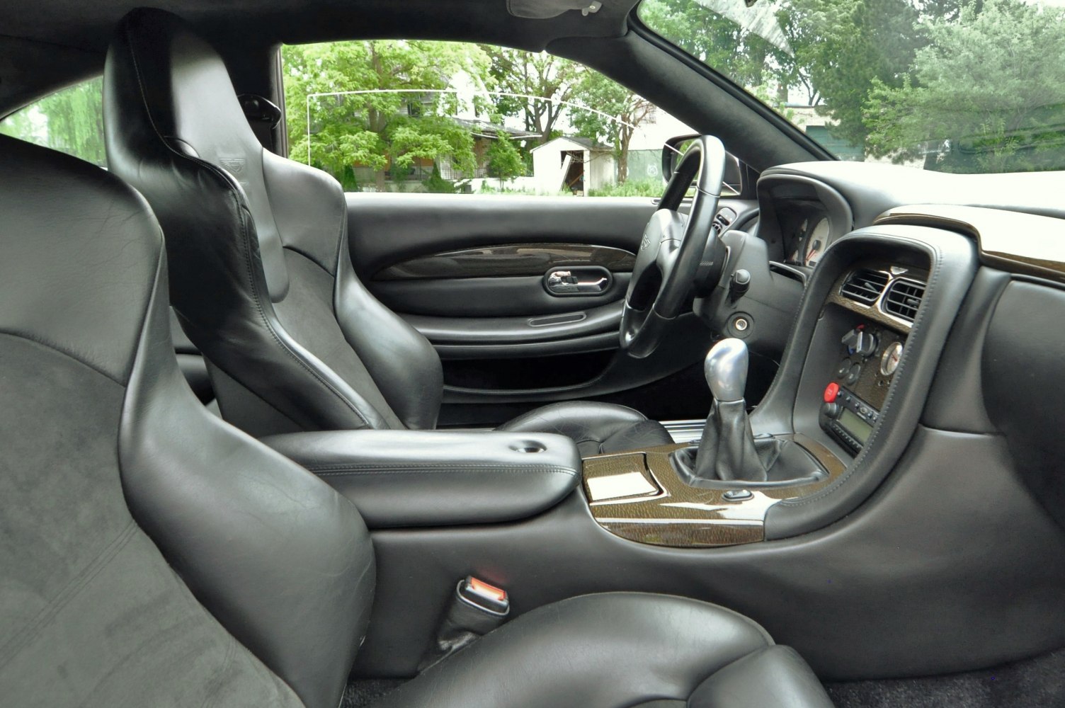 Black leather bucket seats with manual gear shift lever