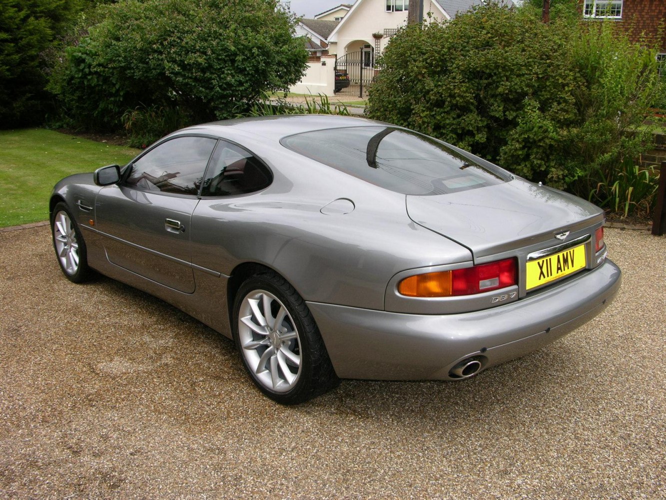 Sleek rear side of a luxury coupe with distinctive tail lights and alloy wheels