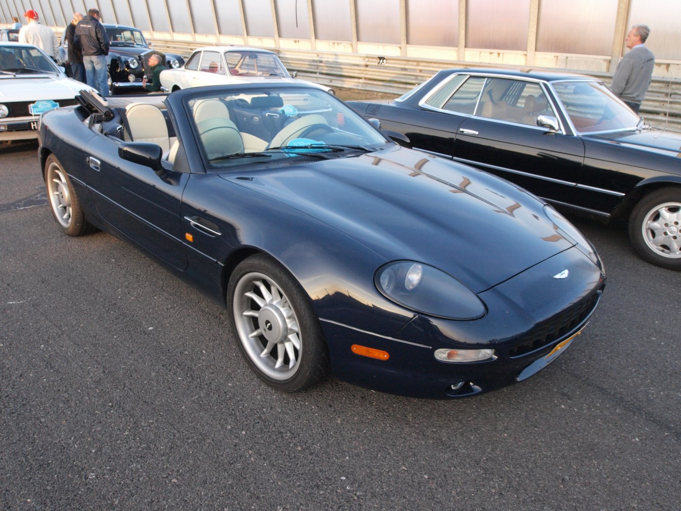 Convertible sports car with rounded headlights and alloy wheels