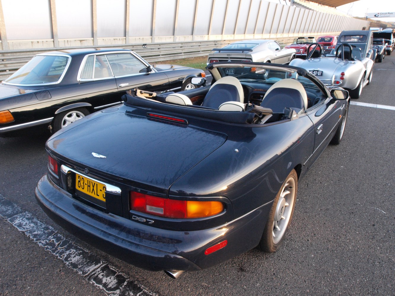 Rear view of classic convertible with open roof and distinctive tail lights