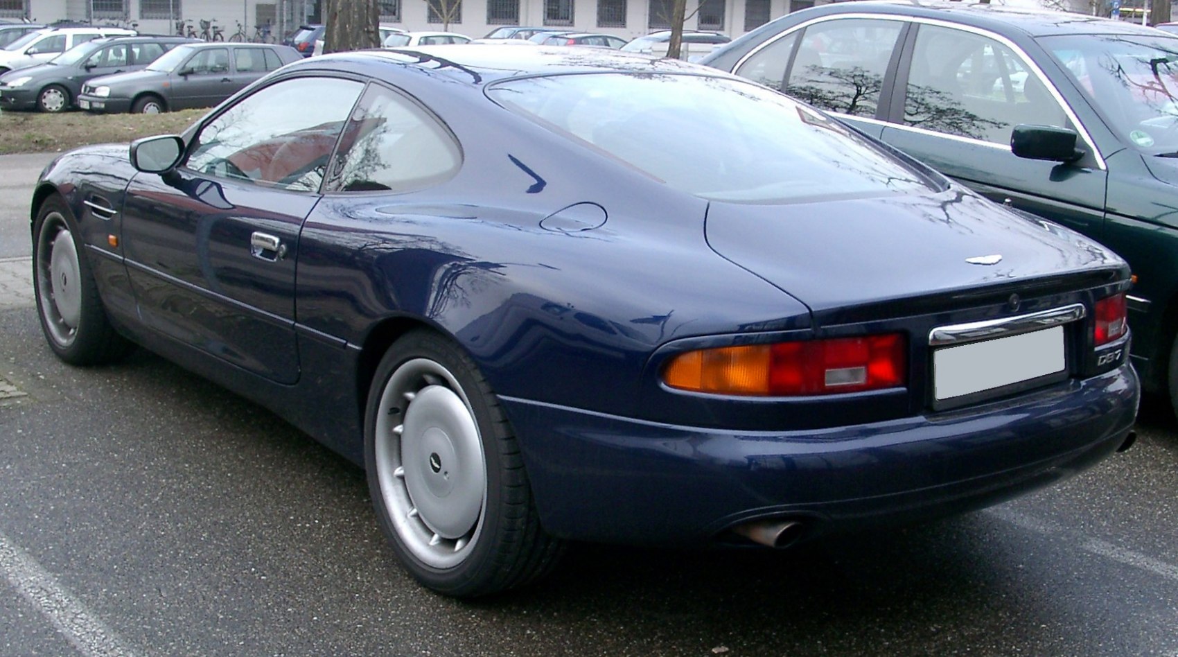 Sleek rear side profile of a classic coupe with smooth body lines and distinctive taillights.