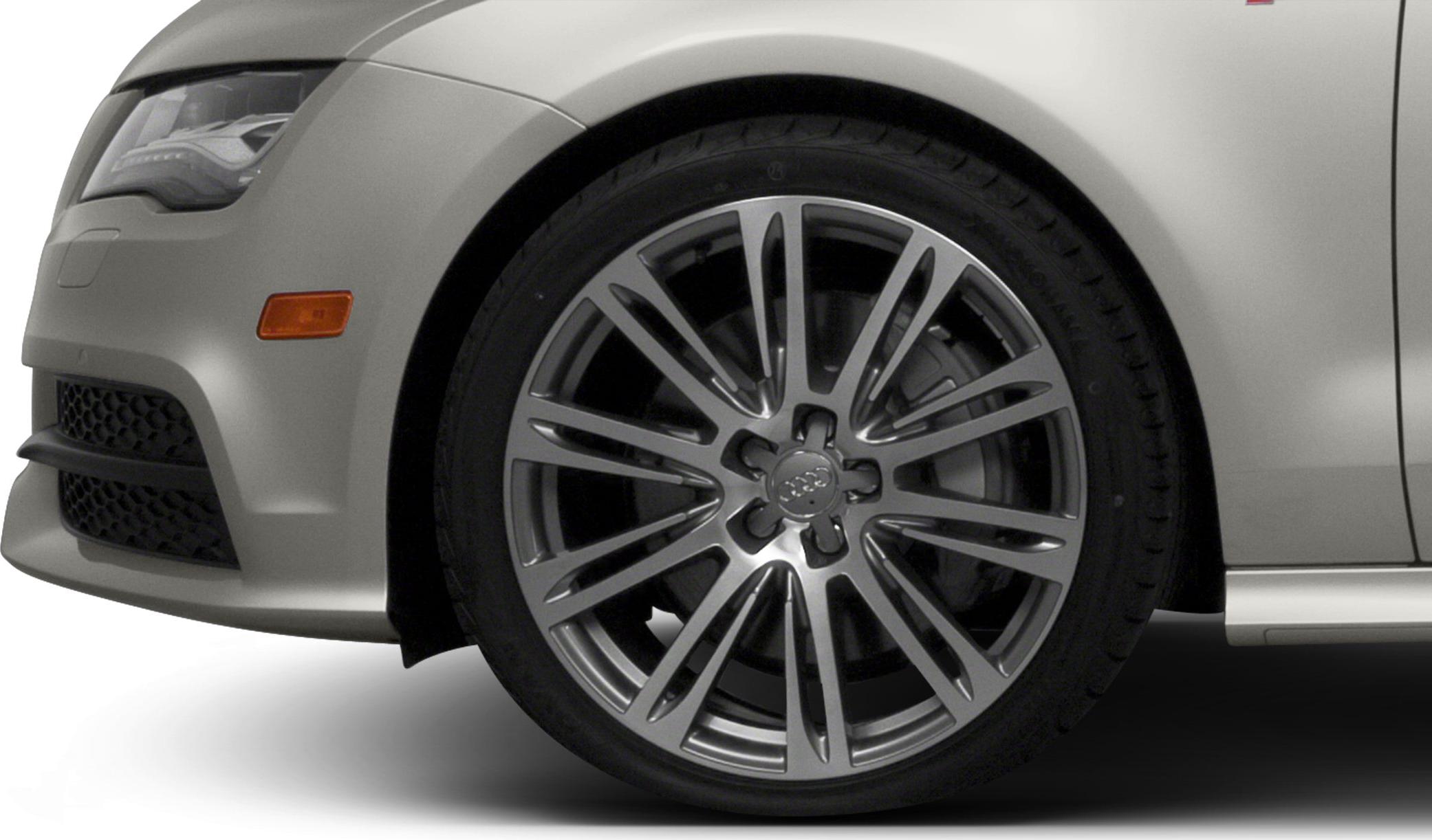 Close-up of front alloy wheel and headlight section