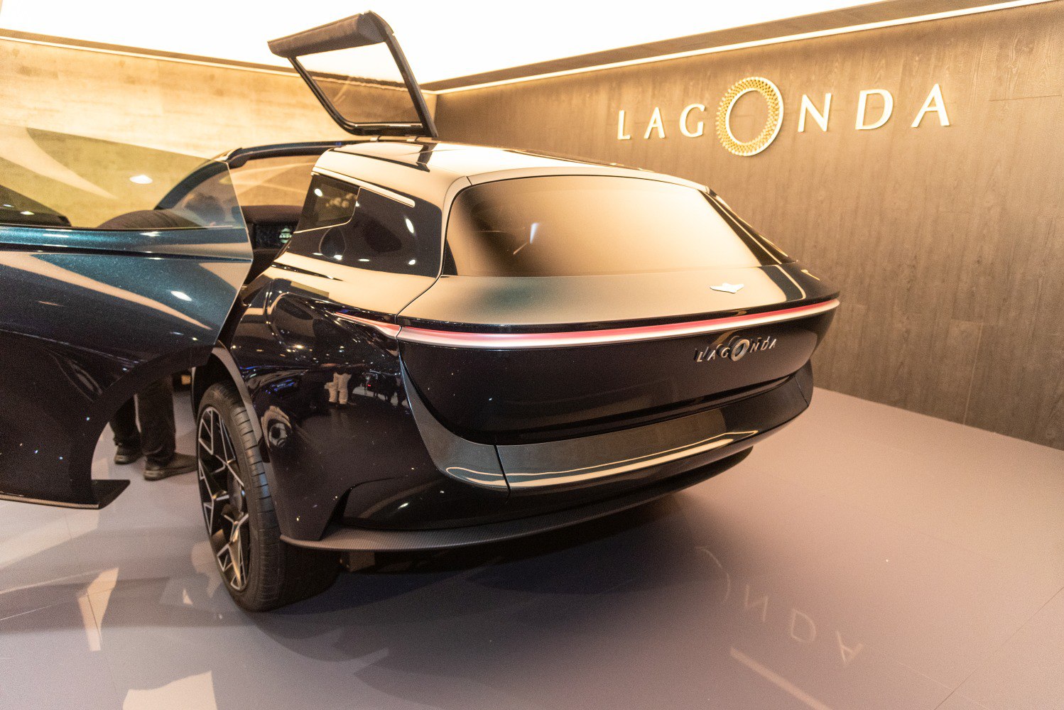 Rear view with sleek taillights and gullwing door open