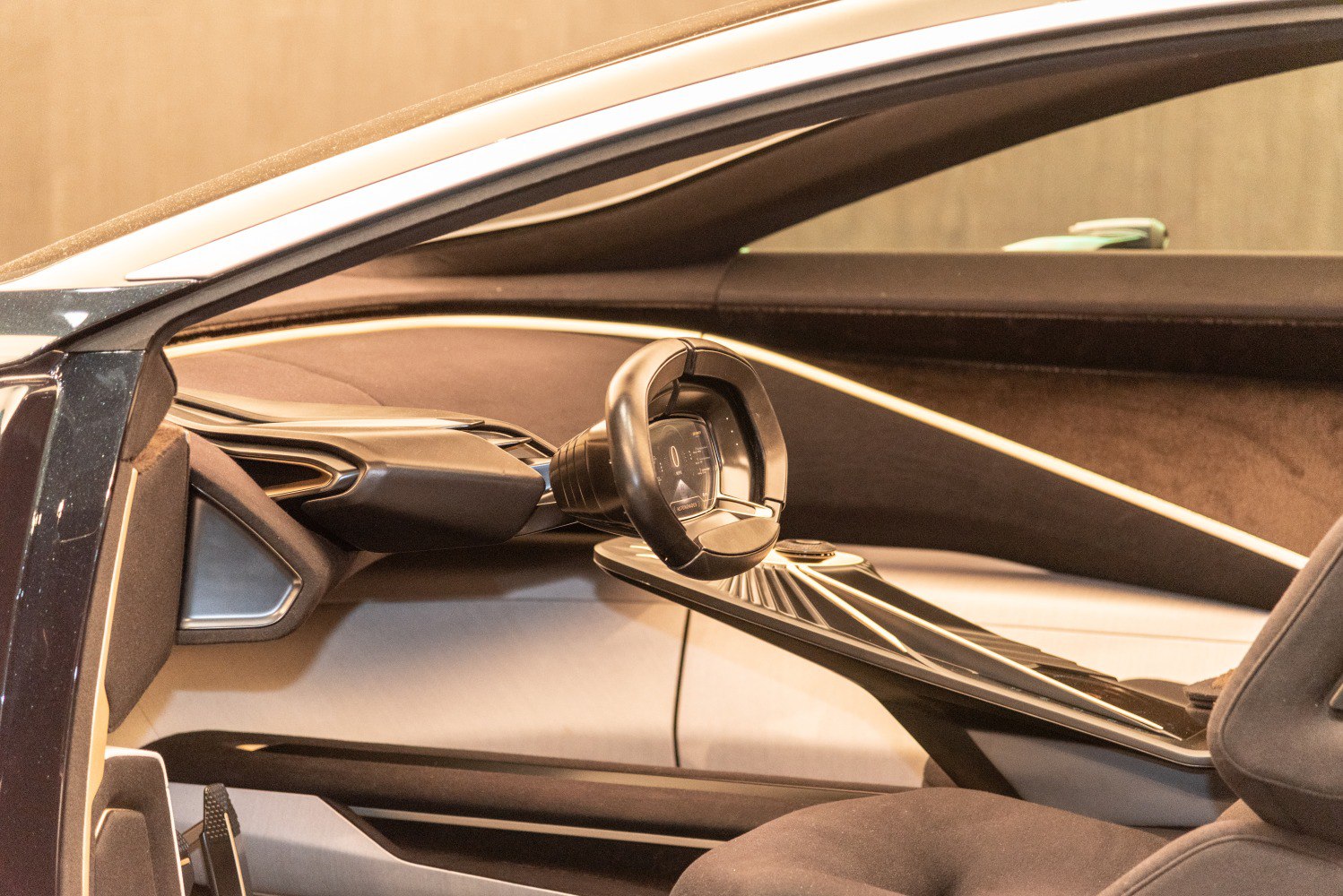 Futuristic steering wheel and sleek dashboard interior with digital display.