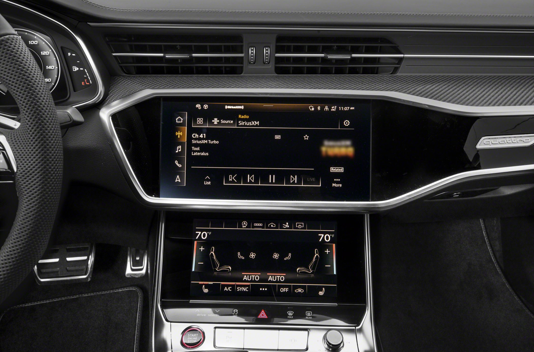 Dual touchscreen infotainment and climate control panels in luxury vehicle interior