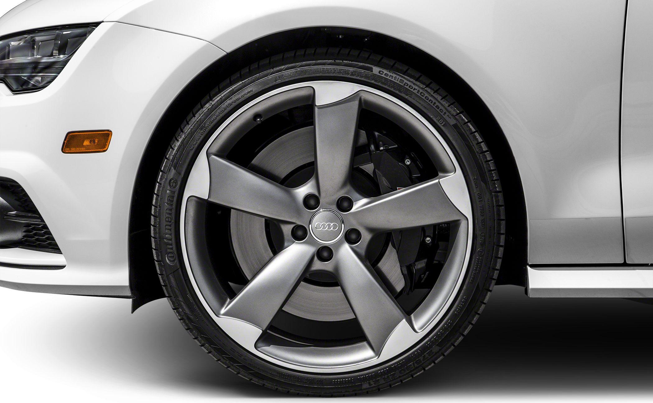 Close-up of five-spoke alloy wheel with ventilated brake disc and tire