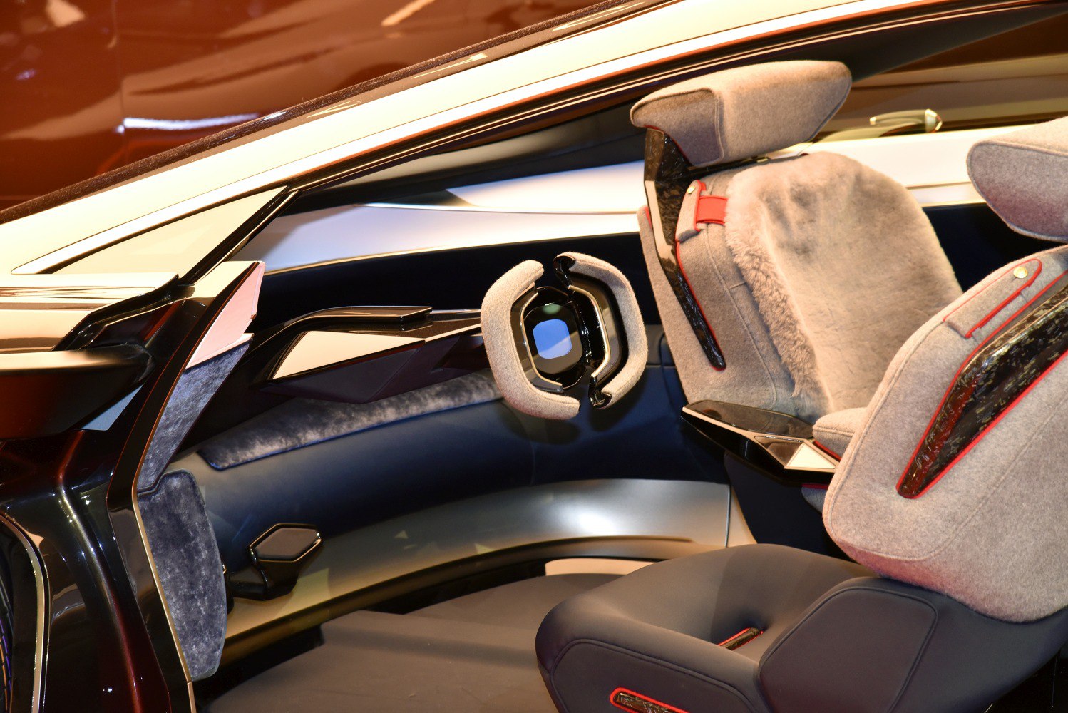 Futuristic car interior with unique steering wheel and plush seats