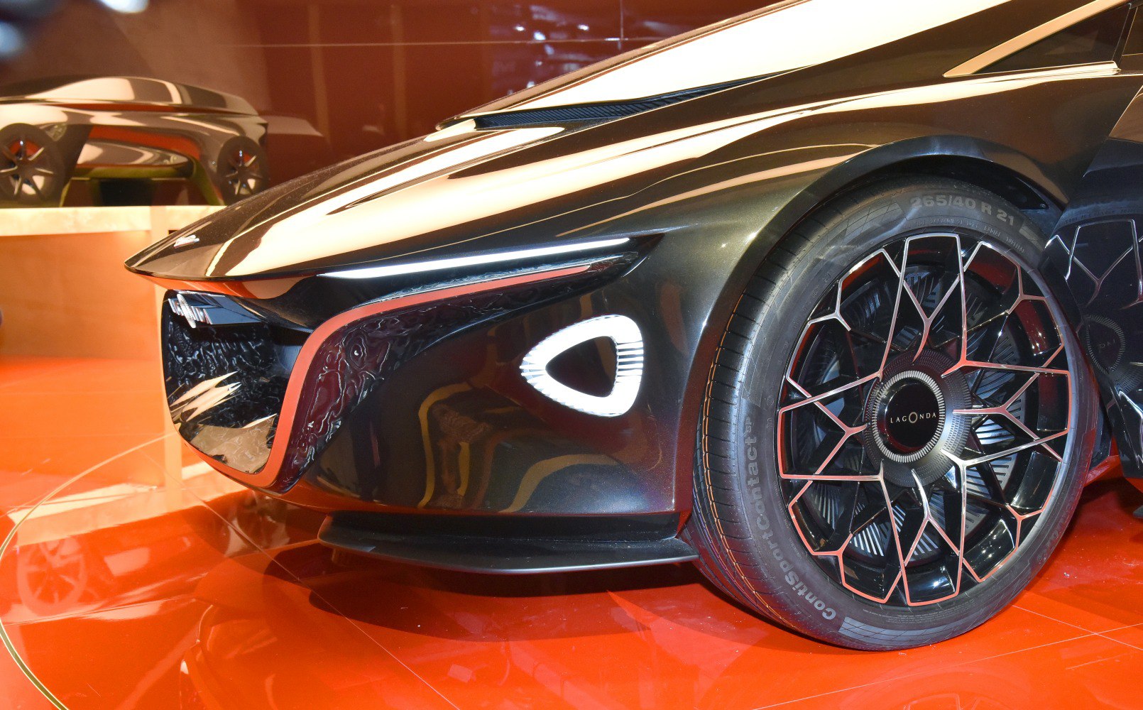 Futuristic front fascia with polygonal lights and intricate alloy wheel design.