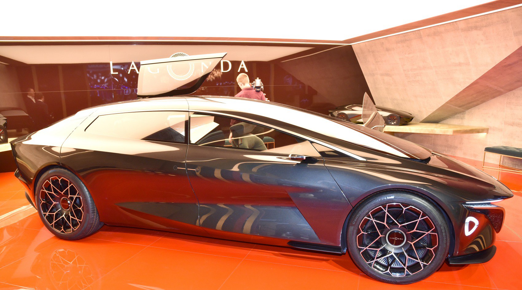 Sleek side profile with gull-wing door and futuristic wheels