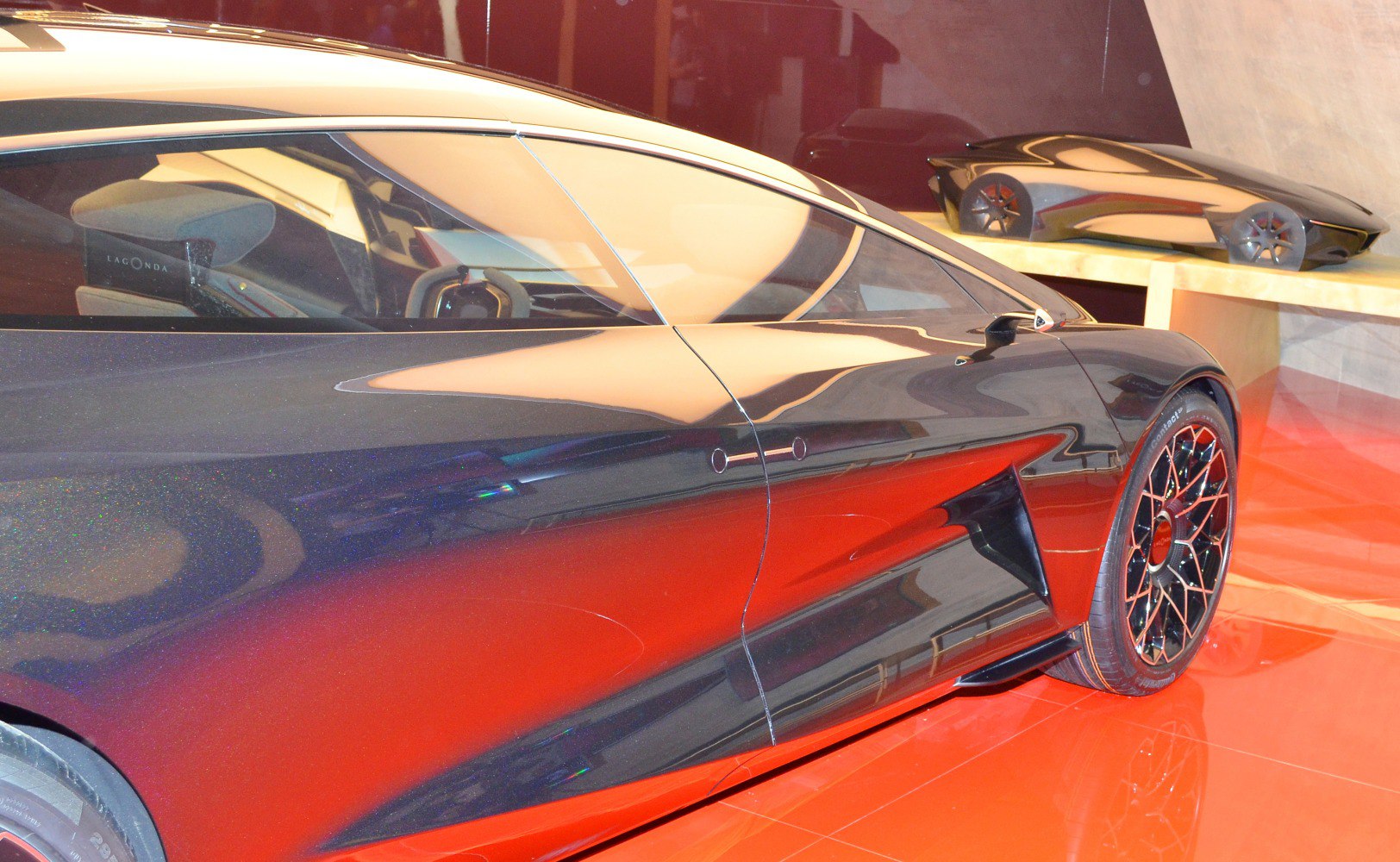 Side view of sleek, aerodynamic futuristic concept car with detailed multi-spoke wheels.