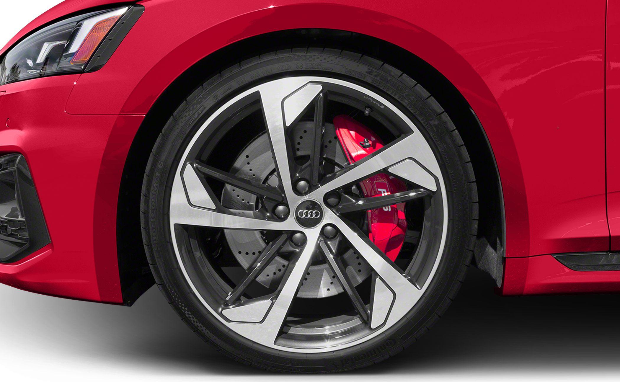Five twin-spoke alloy wheel with red brake caliper and drilled brake disc.