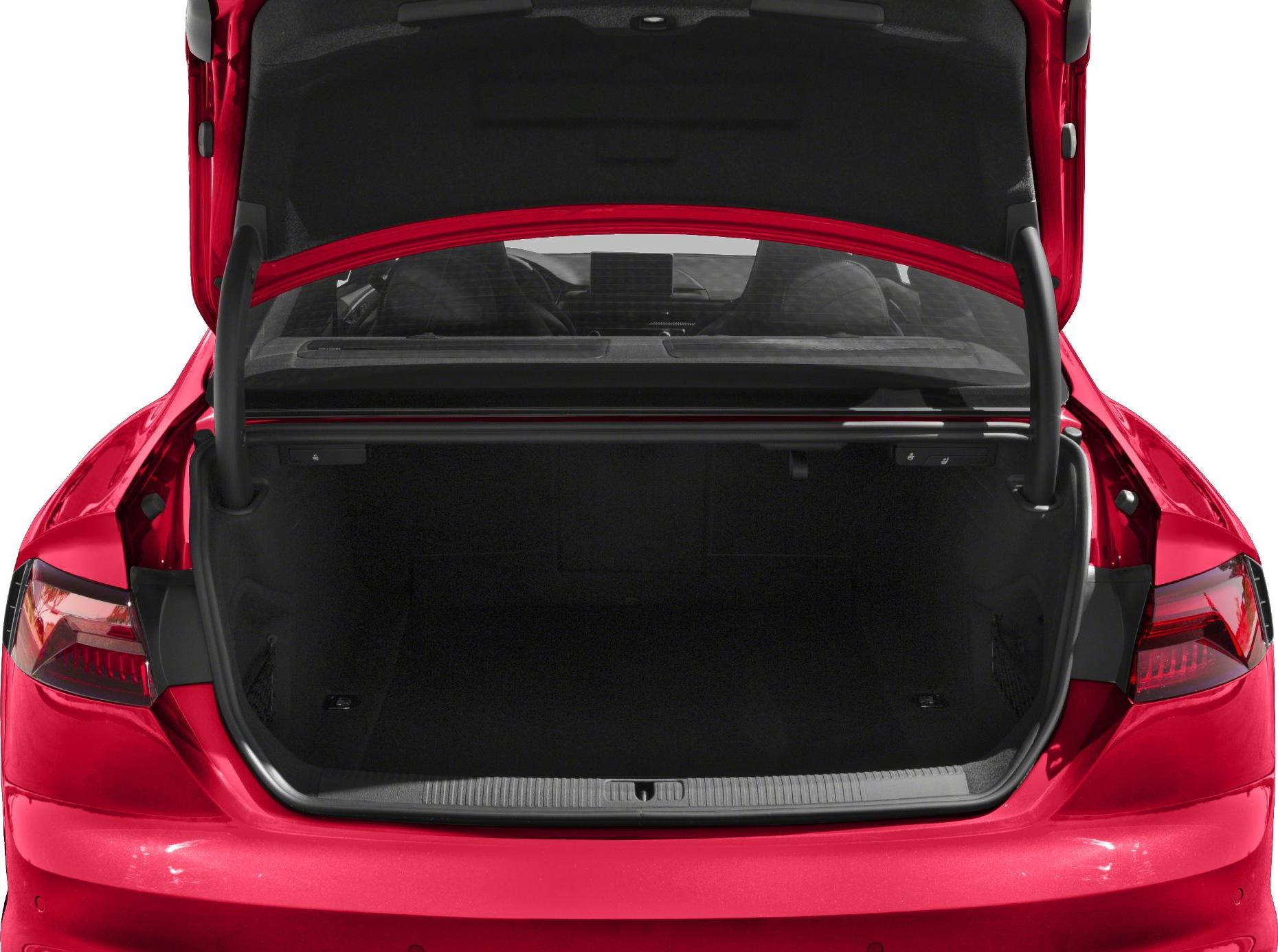 Open trunk of a modern sports sedan with spacious cargo space and visible rear lights.