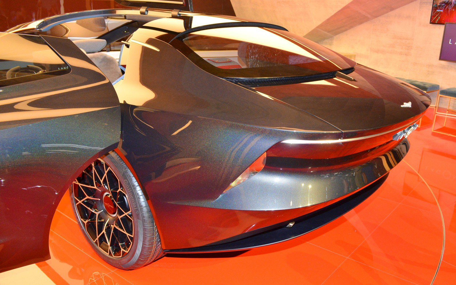 Sleek rear design with futuristic tail lights and intricate alloy wheel