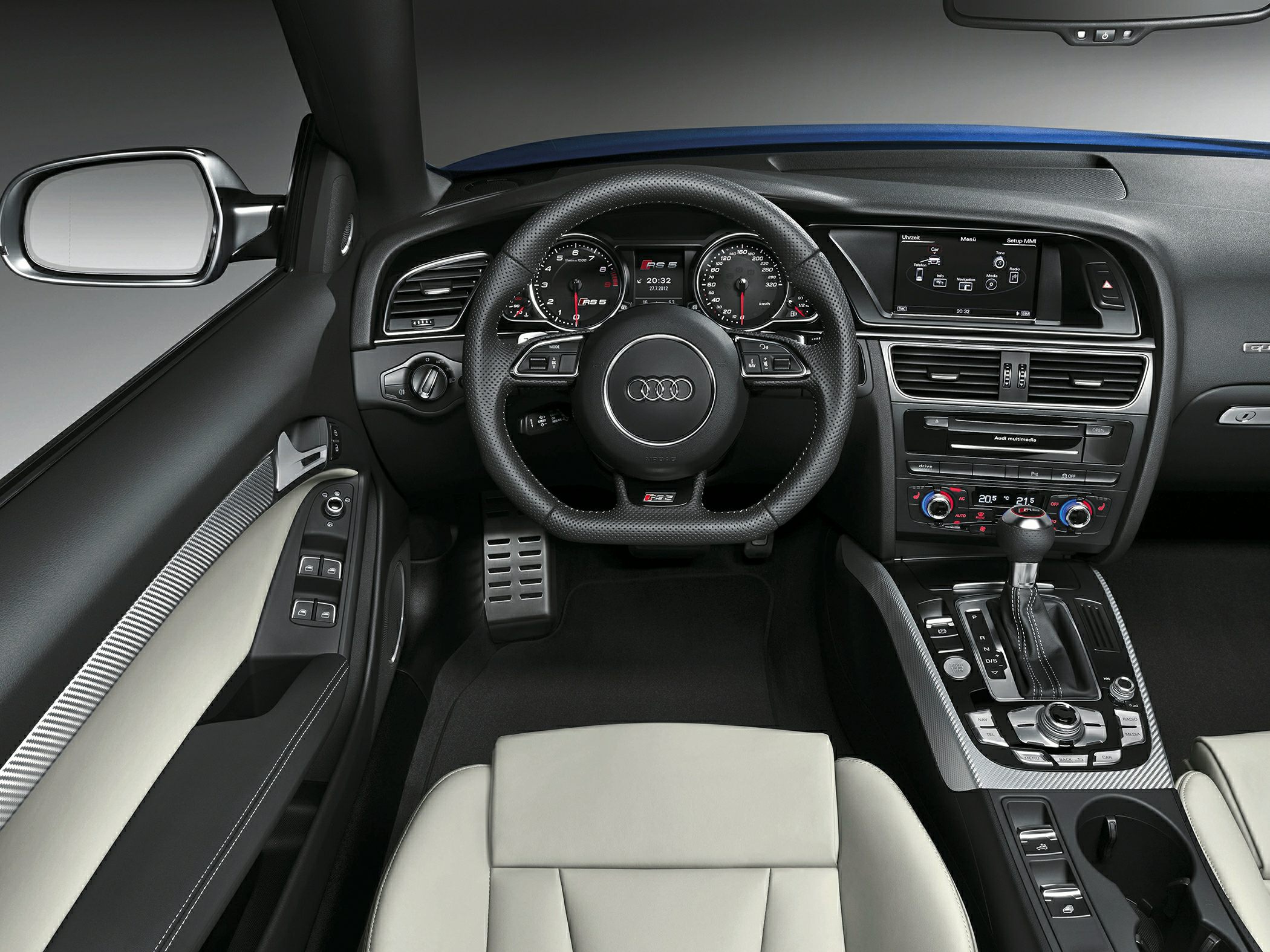 Interior dashboard, steering wheel, and center console of a luxury convertible