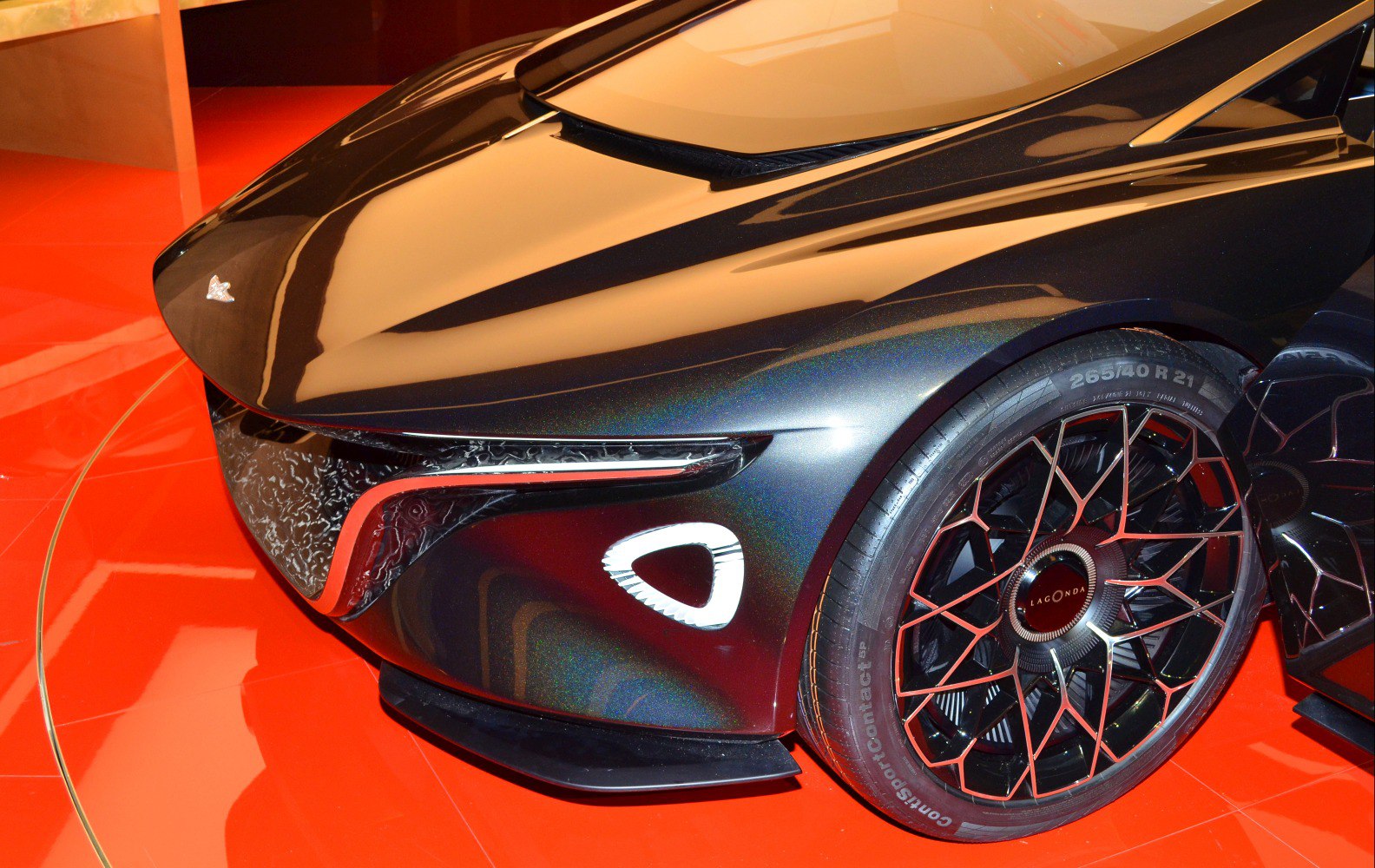 Futuristic front fascia with intricate aerodynamic lines and geometric alloy wheel design.