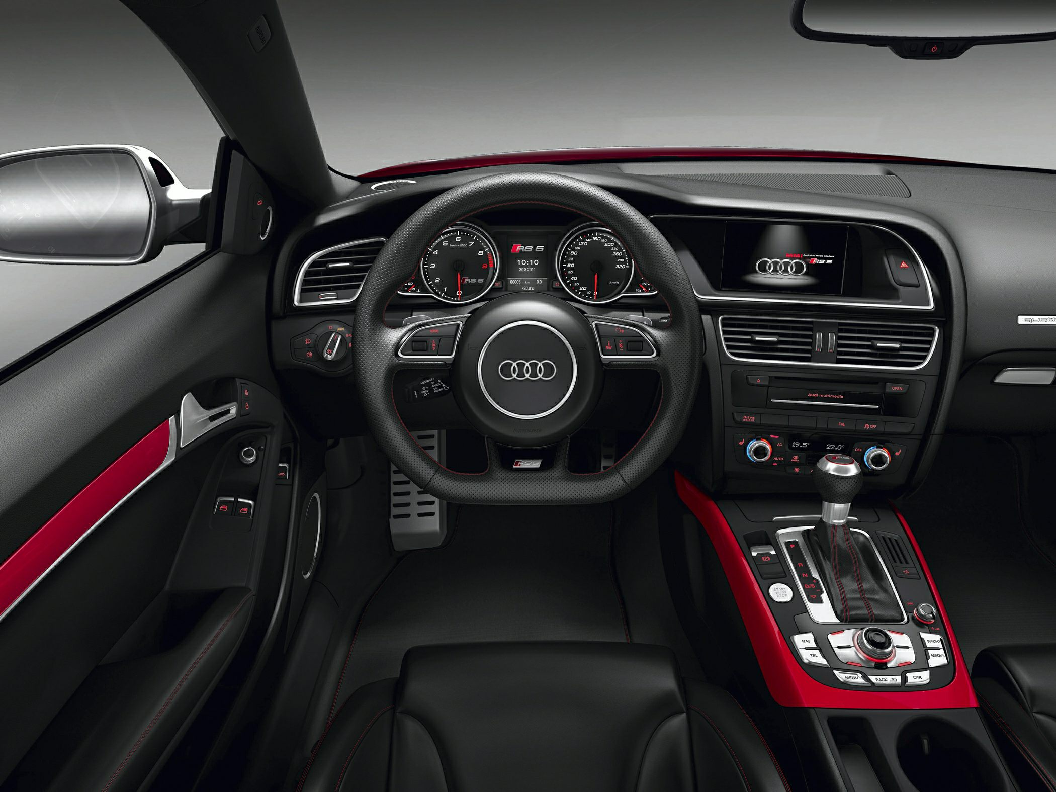Audi RS 5 sporty interior with digital dashboard and red trim accents