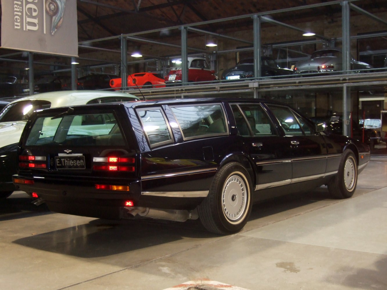 Shooting brake station wagon with sharp rear window and vintage multi-spoke wheels