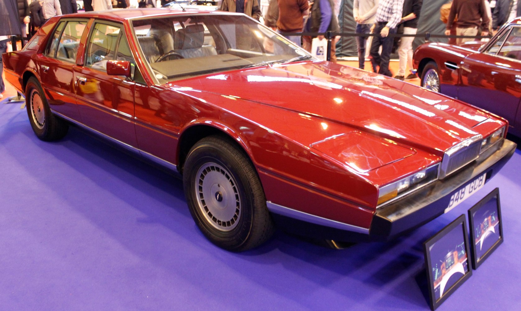 Angular luxury sedan with distinctive front side in red.