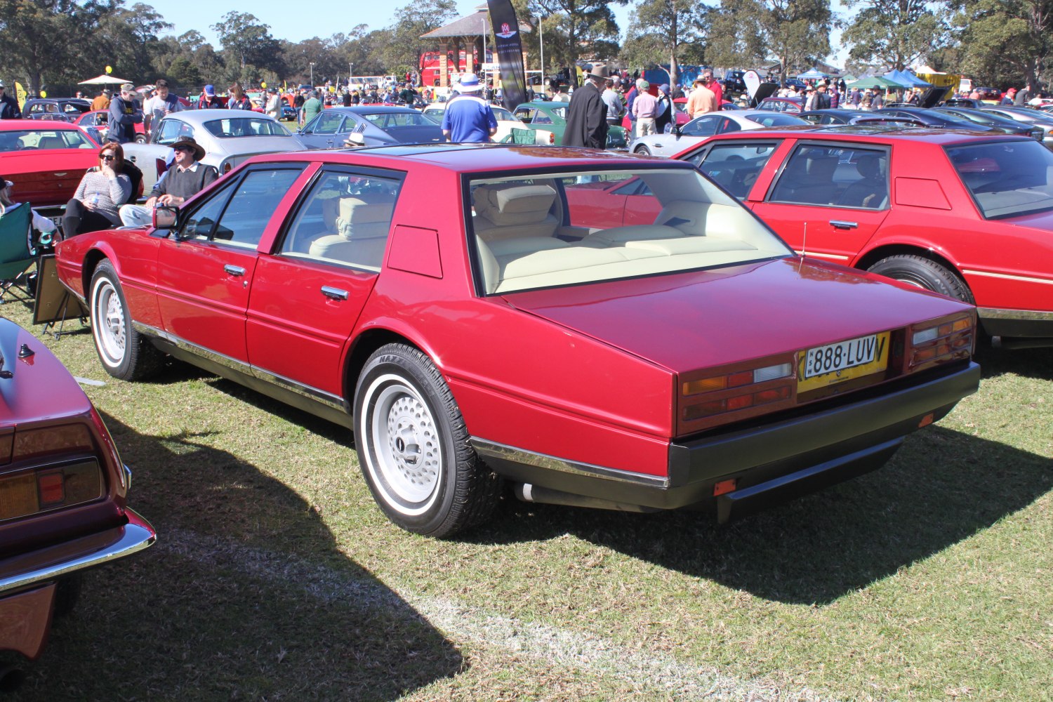 Red four-door sedan with large angular rear window