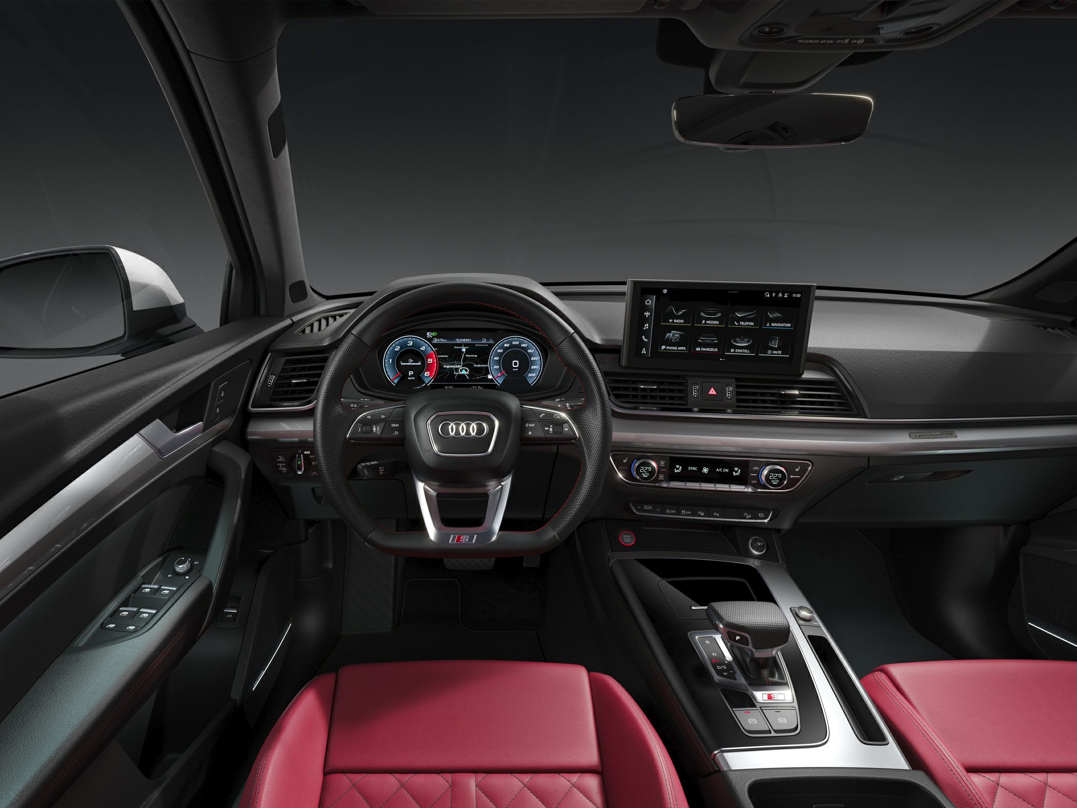 Digital dashboard, infotainment screen, red quilted seats, and sleek center console
