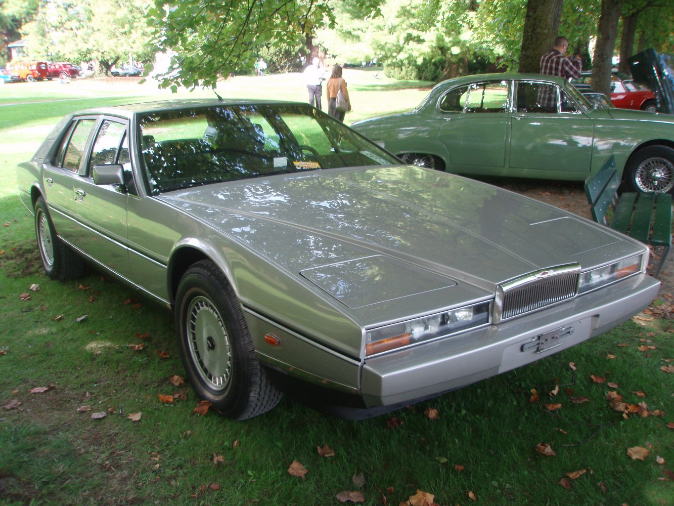 Angular luxury sedan with pop-up headlights and chrome grille