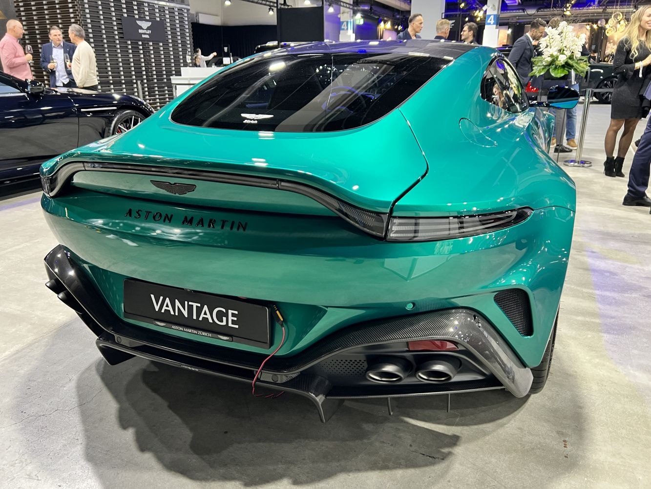 Rear view showing aerodynamic tail lights and dual exhaust of a sports coupe