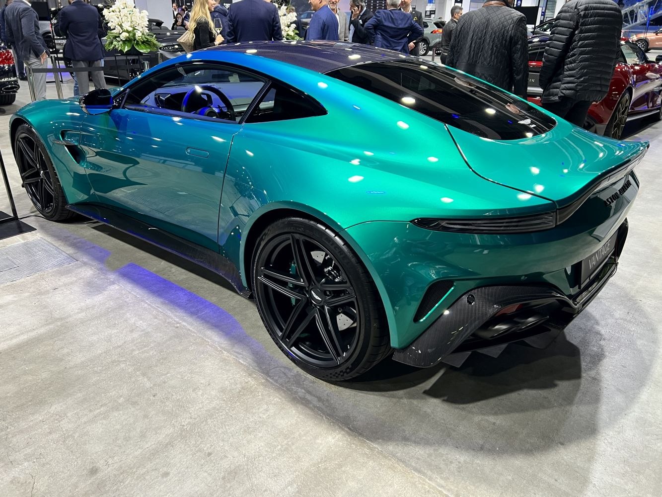 Sleek rear and side of sports coupe with black alloy wheels