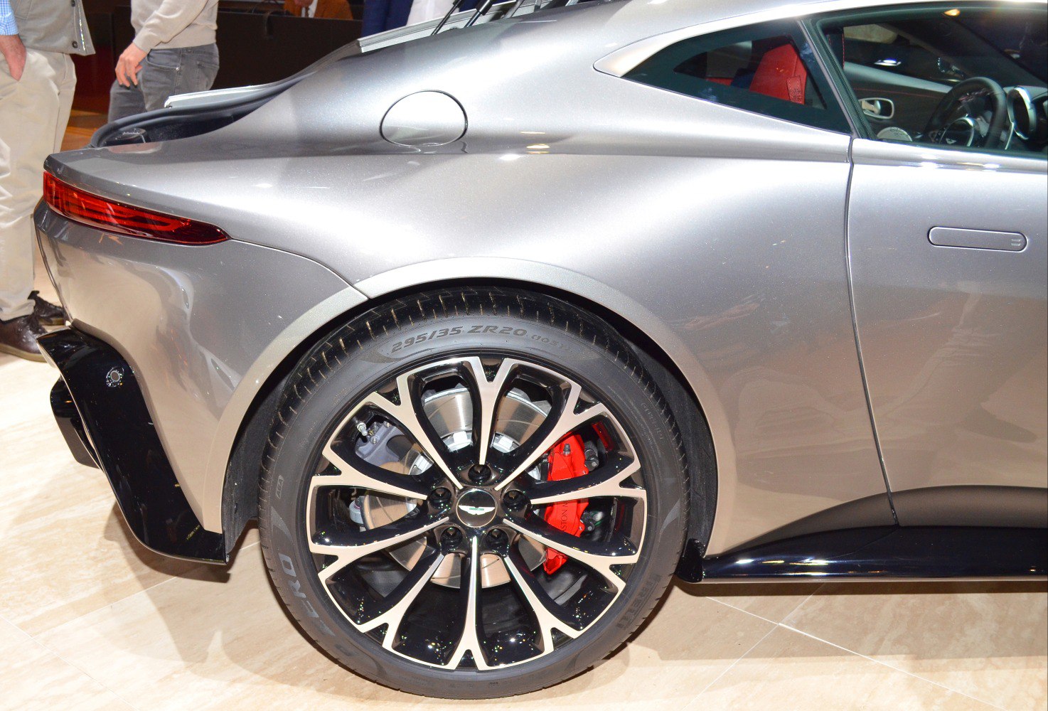 Rear alloy wheel and sleek rear fender design with red brake caliper.