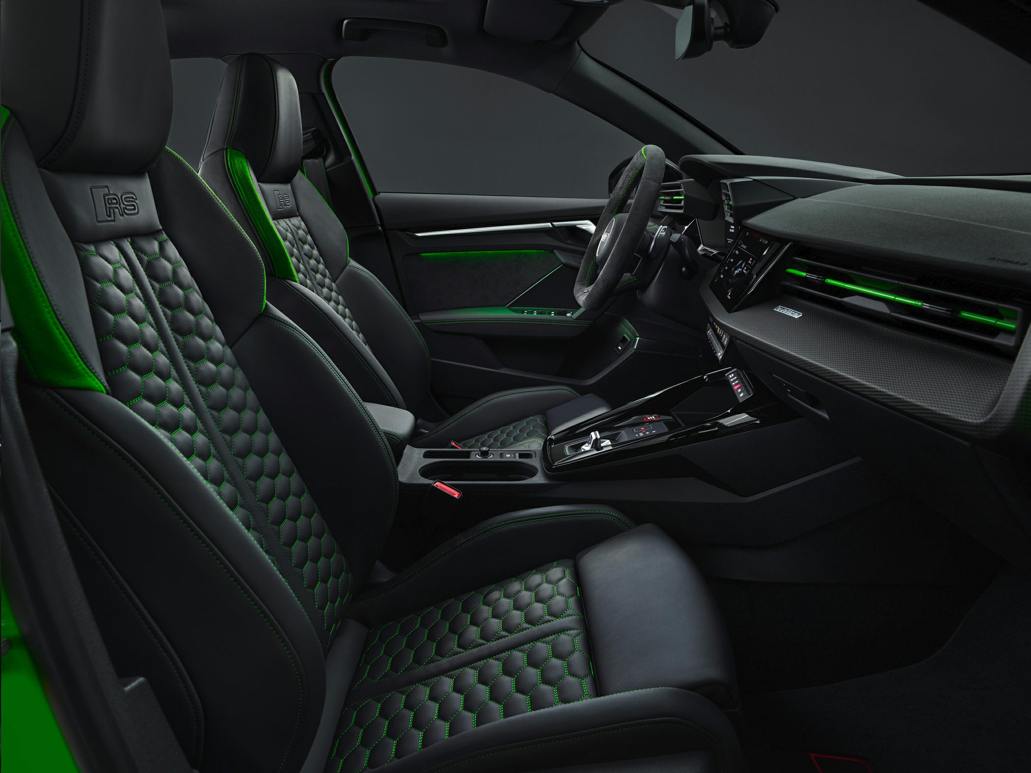 Black and green sporty seats with modern dashboard and steering wheel