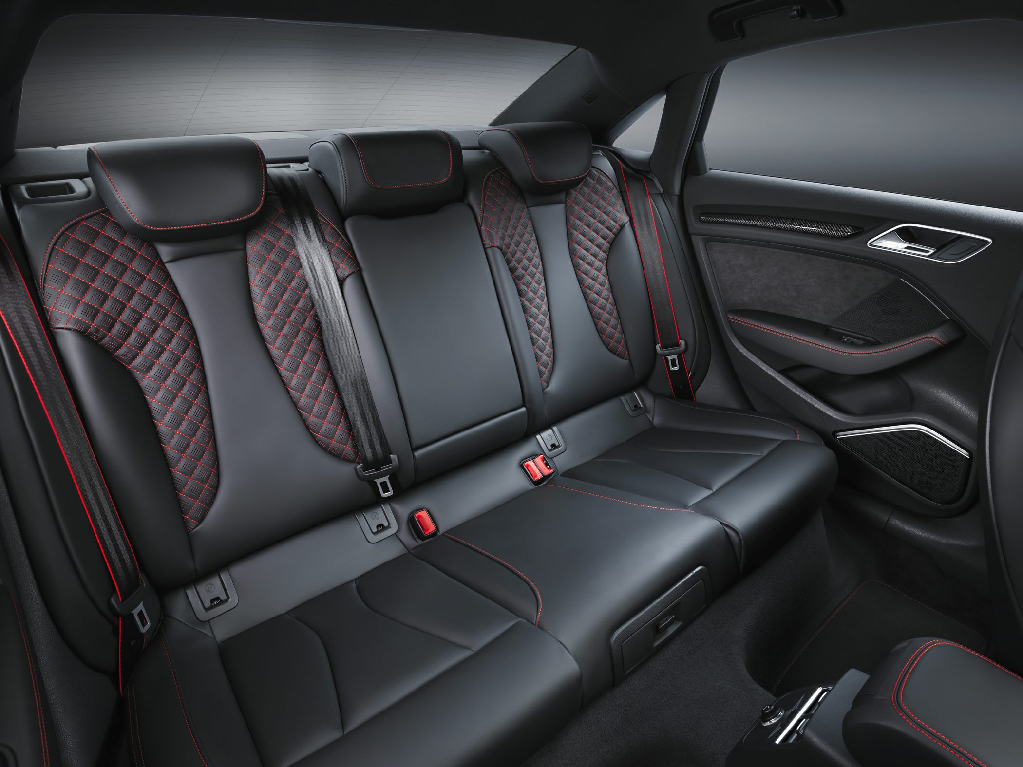 Rear seats with black leather and red stitching.